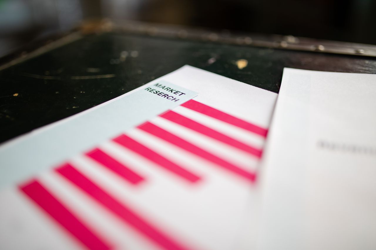 who-we-are A detailed close-up view of a market research report showing a bar chart and highlighting market trend analysis.